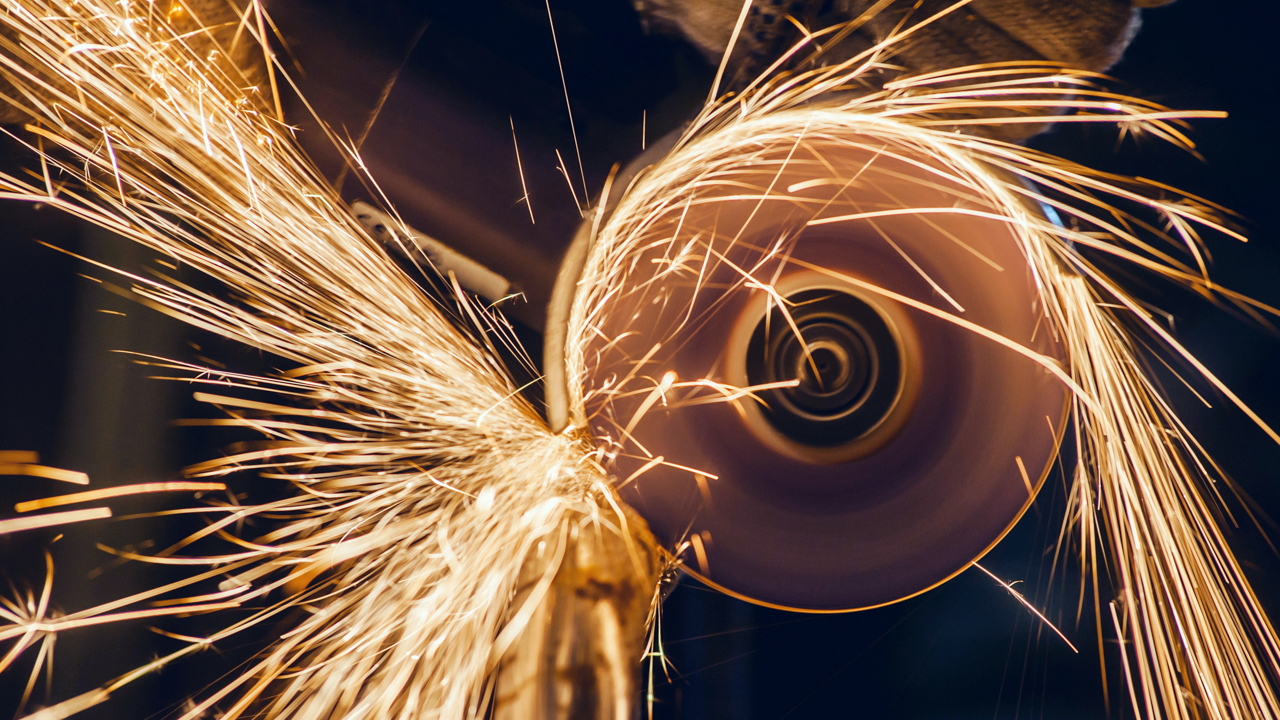 Iron being sharpened on a grinder.