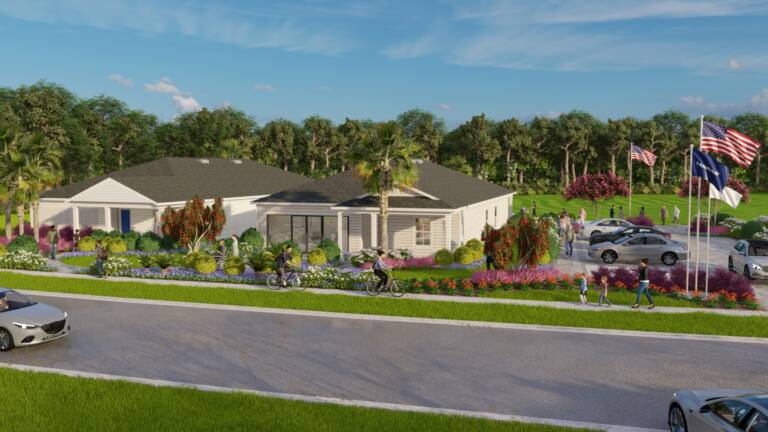 Golf community model park with model homes, flagpoles, and seasonal planting at Stillwater